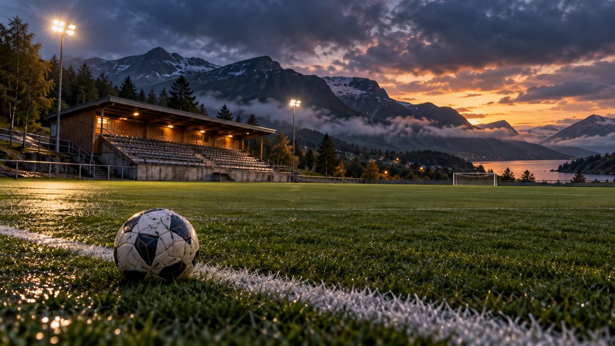 AI-illustrasjon av en tom fotballbane ved fjell, med ball og flomlys i skumringen